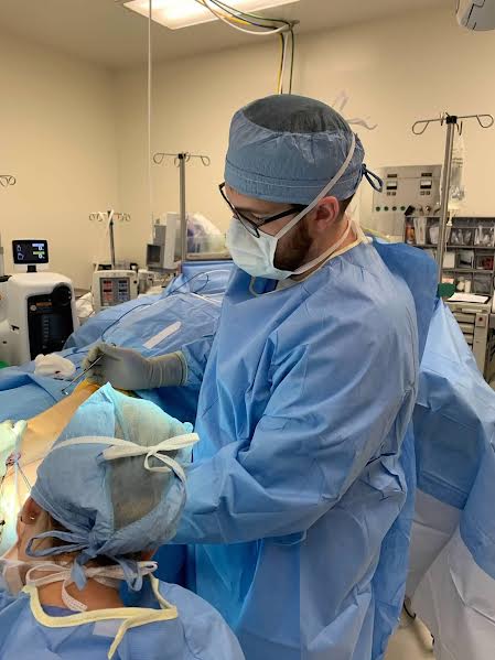 doctor performing surgery in operating room